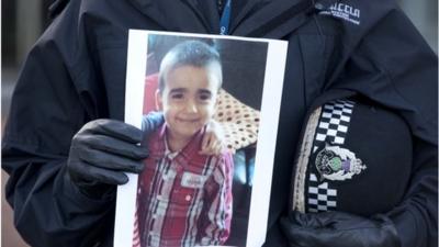 Superintendent Liz McAinsh holds a photo of missing child Mikaeel Kular