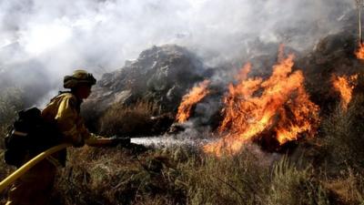 Firefighter tackles California fires