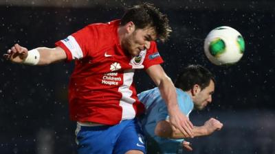 Linfield's Philip Lowry heads in against Ballymena United