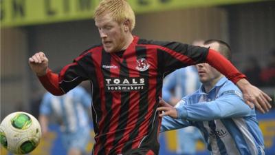 Andy Smith of Crusaders in action against Warrenpoint Town