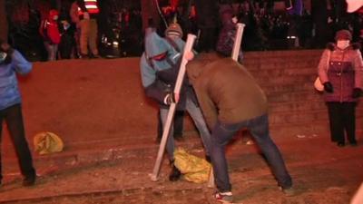 Protesters breaking up pavement