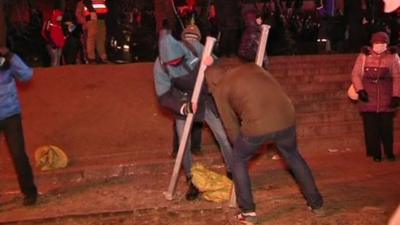 Protesters breaking up pavement