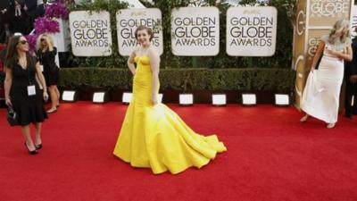 Actress Lena Dunham, from the sitcom "Girls," poses as she arrives at the 71st annual Golden Globe Awards in Beverly Hills, California January 12, 2014