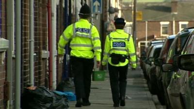 Policeman and policewoman in street