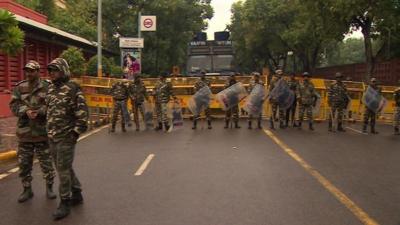 Police stand near the protest