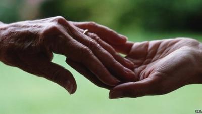 Two people touch hands