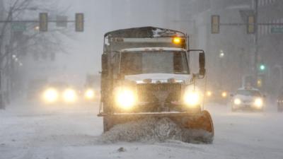 A plough makes its way through Philadelphia, Pennsylvania, on 21 January 2014