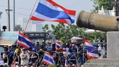 Anti-government protesters wave national flags