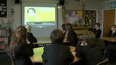 Children watch a presentation