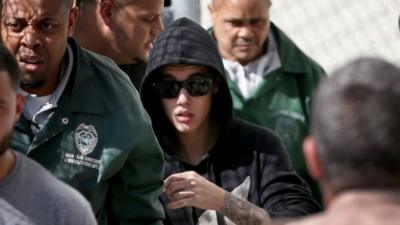 Justin Bieber (centre) exited the Turner Guilford Knight Correctional Center in Miami, Florida, on 23 January 2014