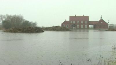 A building surrounded by flooding