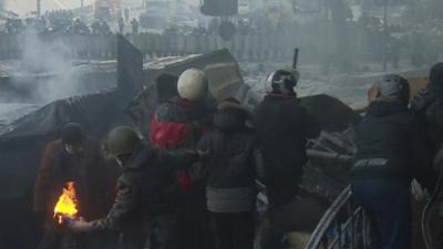 Protester preparing to throw molotov cocktail