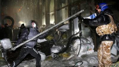 Protesters attack a government building in central Kiev, Ukraine, on 26 January