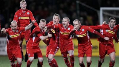 Cliftonville players celebrate their penalty shoot-out win over Crusaders