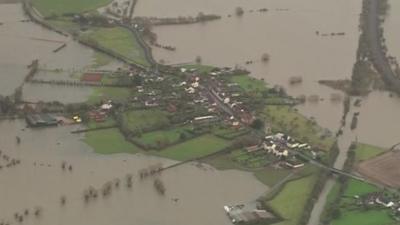 Aerial view of houses surrounded by water