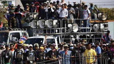 Anti-government protesters lock their arms as they stand at the gates of the Army Club in Bangkok, Thailand, 28 January 2014