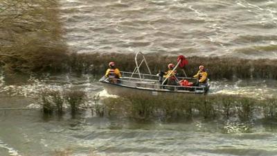 Boat on patrol in flooded Somerset