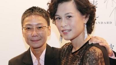 Gigi Chao, right, daughter of the Hong Kong property tycoon Cecil Chao, poses with her partner Sean Eav