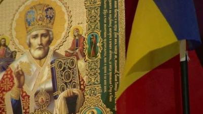 Religious icon and Romanian flag