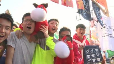 People with a horse toy celebrating new year