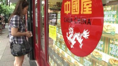 Woman outside 'Casa China' shop