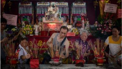 People burn incense sticks