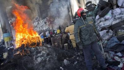 Protesters man a barricade in Kiev