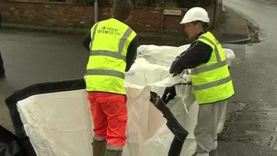 Workmen preparing sandbags