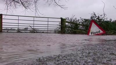 Road showing flood sign