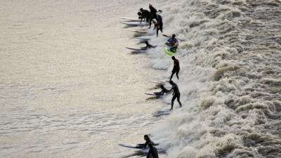 Surfers ride Severn Bore