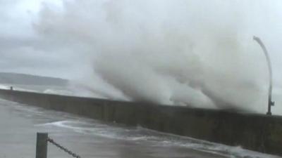 Waves breach sea wall