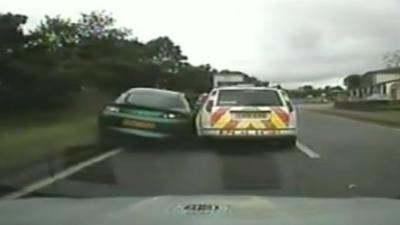 Police car ramming another car off the road