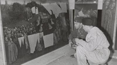 Lt Daniel J Kern and Karl Sieber examine the Ghent Altarpiece in the Altaussee mine, 1945
