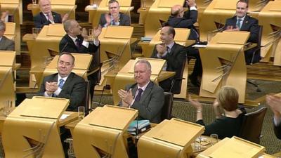 First Minister Alex Salmond was among the MSPs applauding