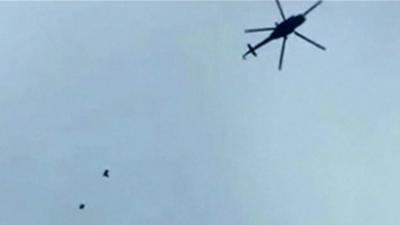 Still from unverified footage appears to show helicopter dropping bombs over Darayya