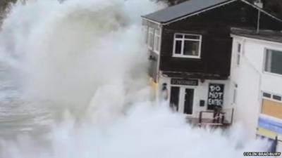 Wave crashing over restaurant