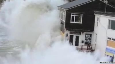 Wave crashing over restaurant