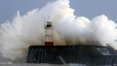 Wave crashing over harbour wall in Sussex