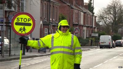 Smiling lollipop lady in Wythenshawe