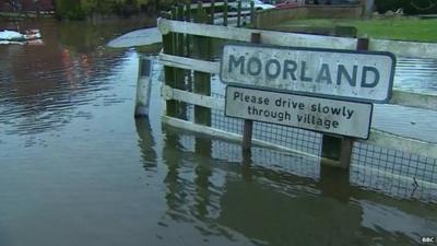 Village sign in flooded village of Moorland, Somerset