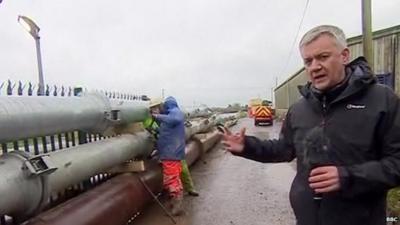 Chris Eakin looks at the emergency pipes pumping floodwater away from the village of Moorland