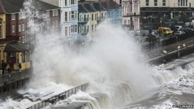 Waves crash against the seafront and railway in Dawlish on February 5