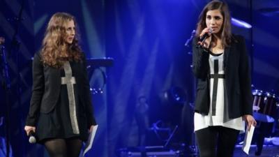 Maria Alyokhina (L) and Nadezhda Tolokonnikova of Pussy Riot speak onstage at the Amnesty International Concert presented by the CBGB Festival at Barclays Center 5 February 2014