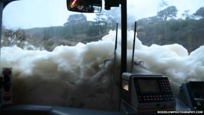 Foam enveloping in Poldhu beach in Mullion, Cornwall