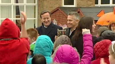 David Cameron and Gary Lineker with trophy at school sports event