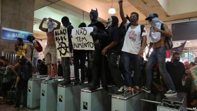 Protesters standing on tickets barriers