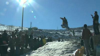 Skier goes over jump