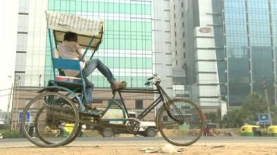 traditional bicycle in front of office blocks