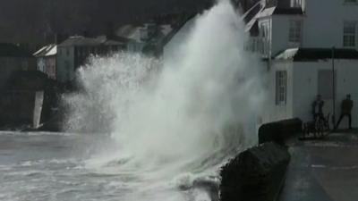 Wave crashing against building