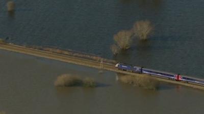 Train on track next to floods